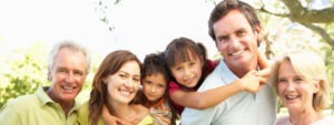 Extended Group Portrait Of Family Enjoying Day In Park